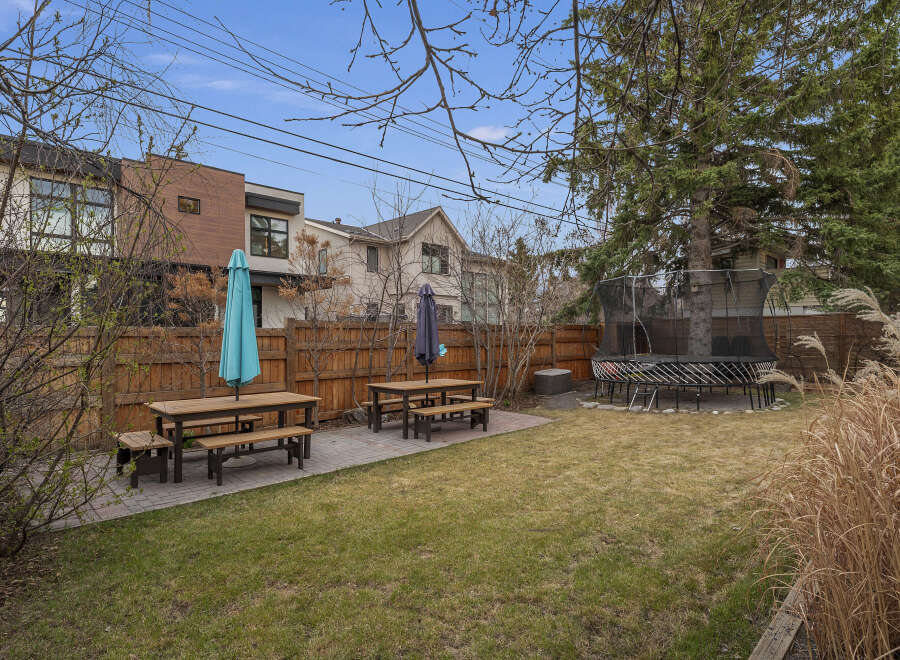 Enjoy outdoor living in this beautiful backyard! This property features a spacious lawn, perfect for entertaining or relaxing.