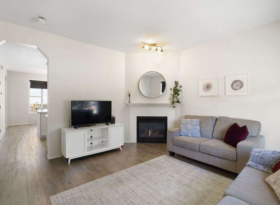 This stunning property boasts a cozy living room with a fireplace, perfect for relaxing evenings.