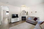 This stunning property boasts a cozy living room with a fireplace, perfect for relaxing evenings.