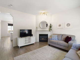 This stunning property boasts a cozy living room with a fireplace, perfect for relaxing evenings.