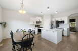 This stunning kitchen and dining area offers a bright and inviting space for both cooking and entertaining.