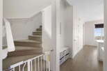 Step into this inviting home featuring a staircase with carpeted steps and a safety gate, perfect for families.