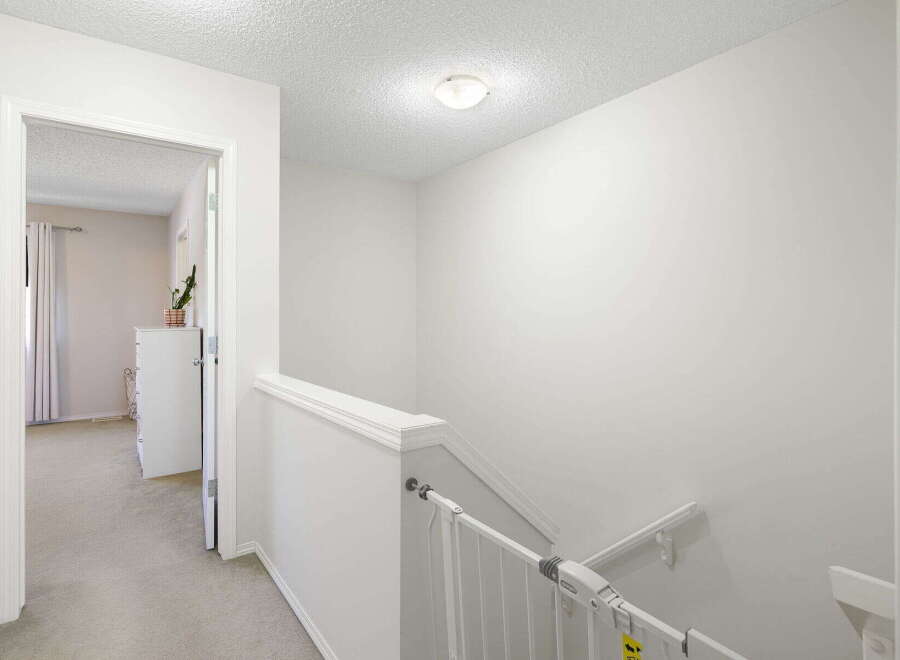 This bright and airy hallway features a neutral color palette, creating a welcoming atmosphere.
