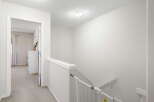 This bright and airy hallway features a neutral color palette, creating a welcoming atmosphere.