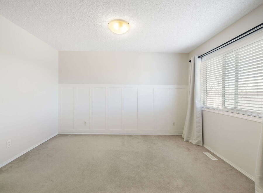 This inviting room features a neutral color palette, creating a versatile space ready for personalization.