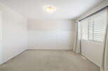 This inviting room features a neutral color palette, creating a versatile space ready for personalization.