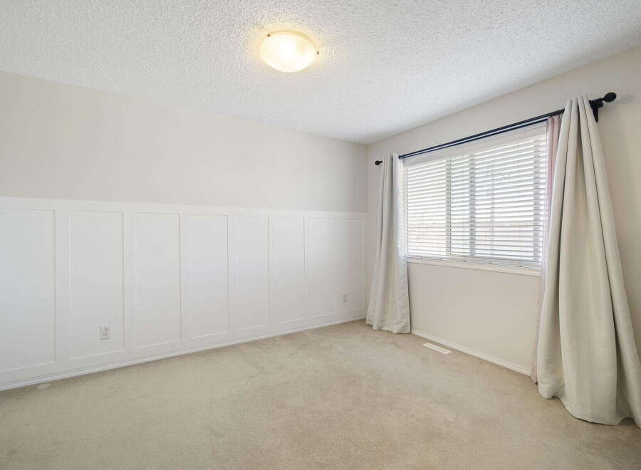This inviting room features a neutral color palette, creating a sense of calm and spaciousness.