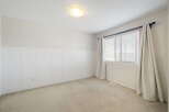 This inviting room features a neutral color palette, creating a sense of calm and spaciousness.
