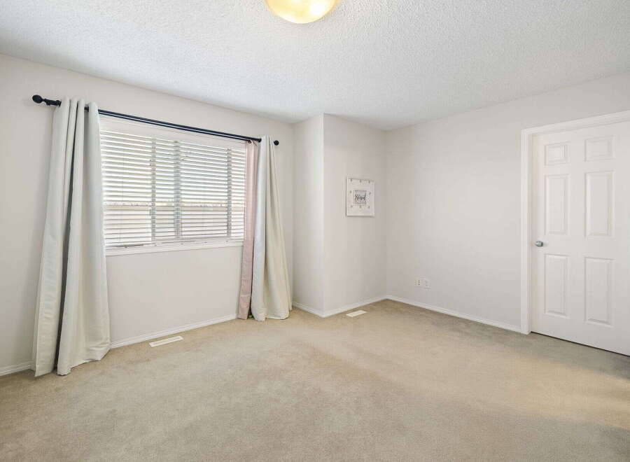 This inviting room features a neutral color palette, creating a versatile space ready for personalization.