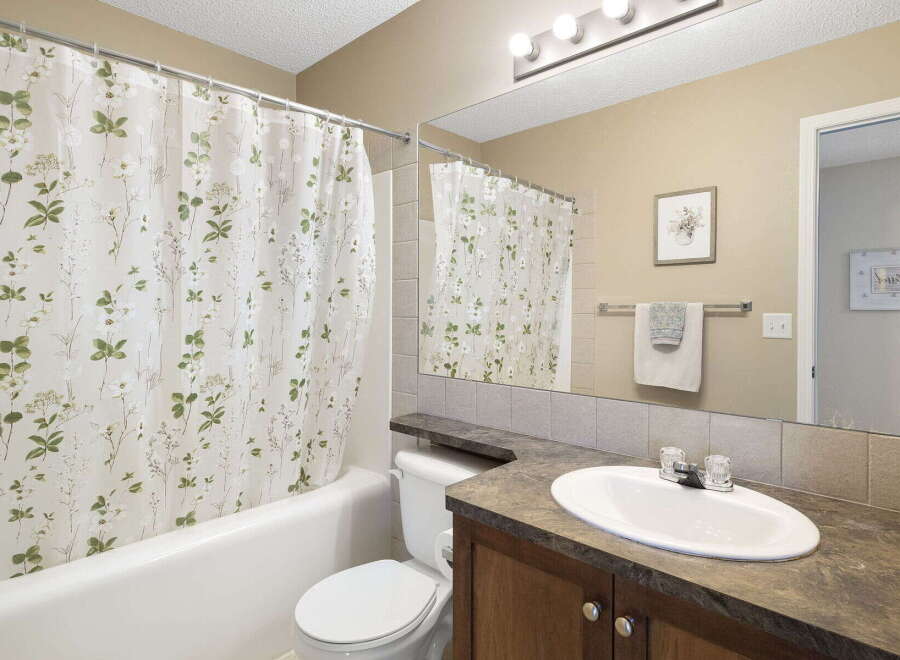 Step into this inviting bathroom featuring a stylish shower curtain with a floral design.