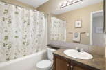 Step into this inviting bathroom featuring a stylish shower curtain with a floral design.