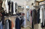 Step into this organized walk-in closet, a perfect addition to any home.