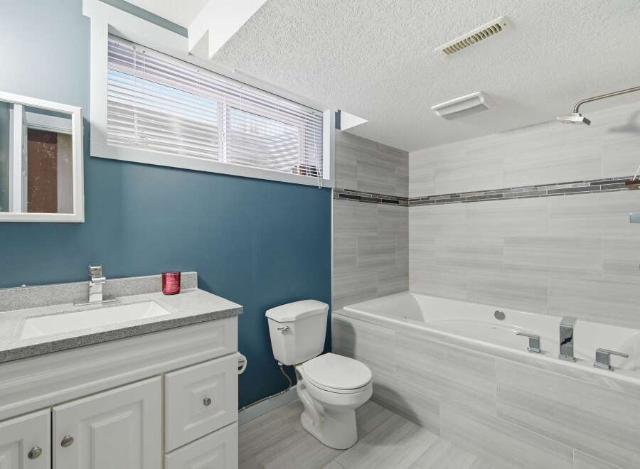 This stunning bathroom boasts a modern design with sleek finishes and ample space.