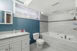 This stunning bathroom boasts a modern design with sleek finishes and ample space.