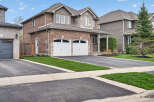 This stunning two-story home boasts a beautiful brick exterior and a well-manicured lawn, perfect for curb appeal.