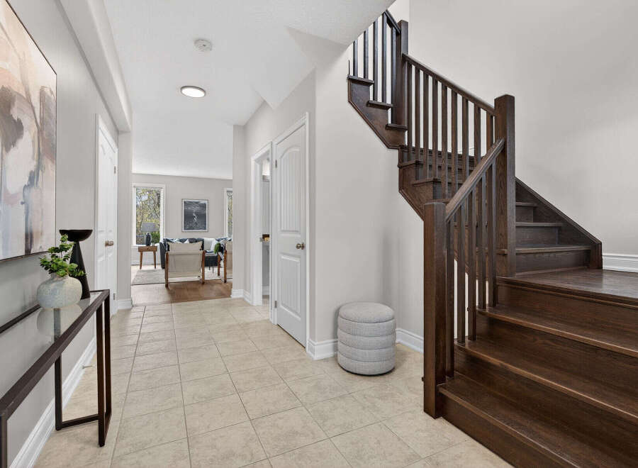 Step into this stunning home and be greeted by a grand staircase and elegant entryway.