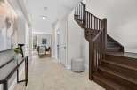 Step into this stunning home and be greeted by a grand staircase and elegant entryway.