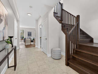 Step into this stunning home and be greeted by a grand staircase and elegant entryway.