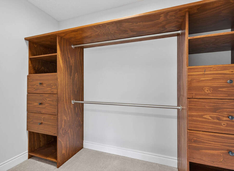 This custom-built closet offers ample storage and organization.