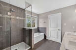 Step into luxury with this stunning bathroom! Featuring a modern walk-in shower with sleek glass doors and elegant tile work, this space is designed for relaxation.