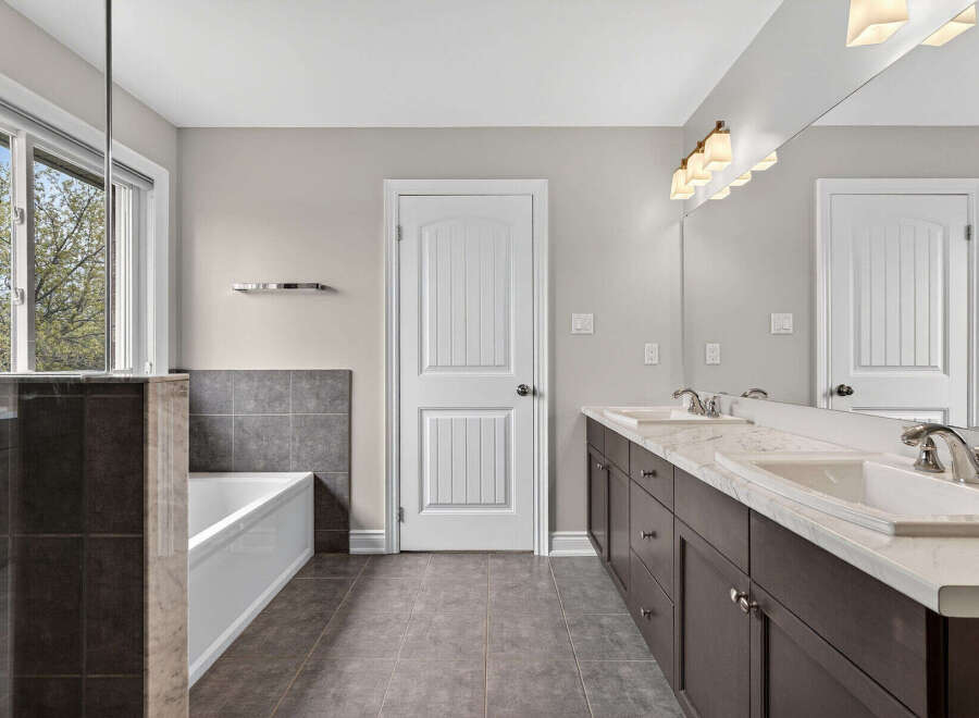 Step into luxury with this stunning bathroom featuring a sleek design and modern amenities.