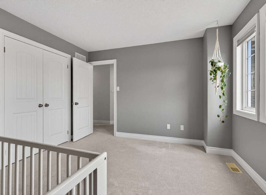Step into this bright and airy bedroom, featuring a neutral color palette and ample natural light.