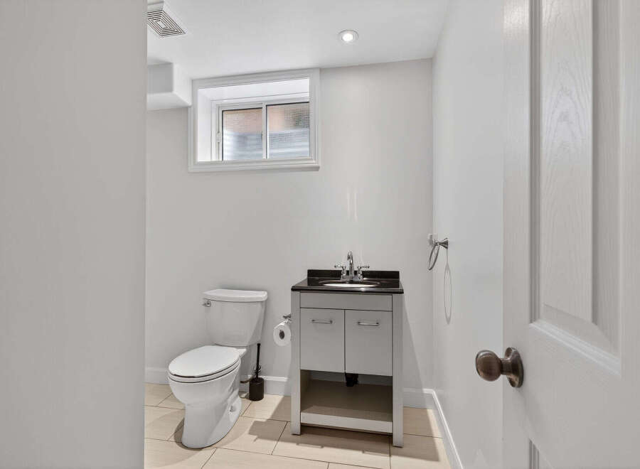 This well-appointed bathroom features a modern vanity with a sleek countertop and ample storage.