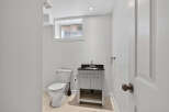 This well-appointed bathroom features a modern vanity with a sleek countertop and ample storage.