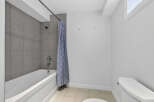 Step into a modern bathroom featuring a sleek bathtub and a stylish shower curtain.