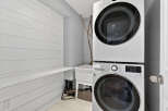 This stunning laundry room boasts a modern design with a stacked LG washer and dryer, maximizing space and efficiency.