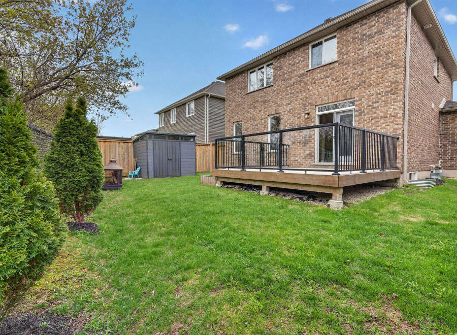 Enjoy outdoor living in this beautiful backyard! This property features a spacious deck, perfect for entertaining or relaxing.