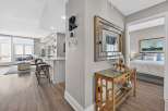 Step into luxury with this stunning property, featuring a modern kitchen with sleek countertops and stylish bar stools.