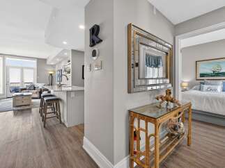 Step into luxury with this stunning property, featuring a modern kitchen with sleek countertops and stylish bar stools.