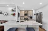 This stunning kitchen boasts a modern design with sleek countertops and ample storage.
