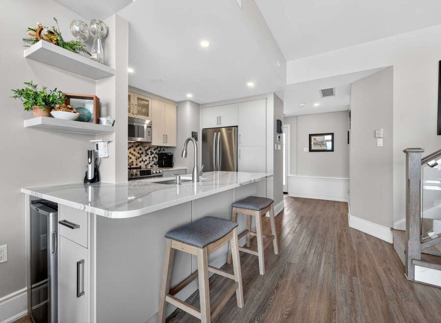 This stunning kitchen boasts a modern design with sleek countertops and ample storage.