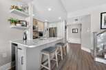 This stunning kitchen boasts a modern design with sleek countertops and ample storage.