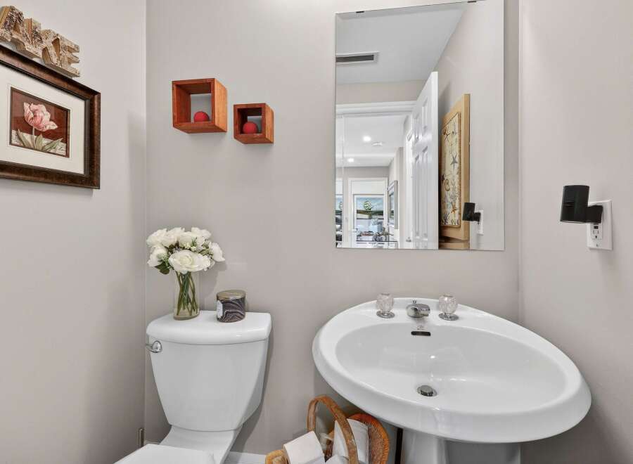 This charming powder room features a pedestal sink, perfect for guests.