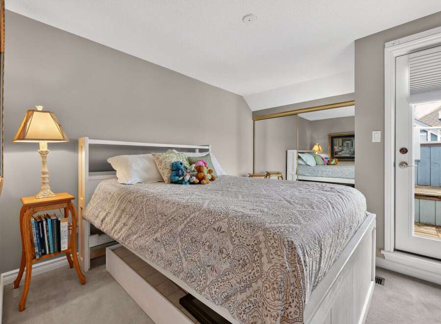 This inviting bedroom features a comfortable bed with a stylish patterned comforter.