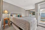 This inviting bedroom features a comfortable bed with a stylish patterned comforter.