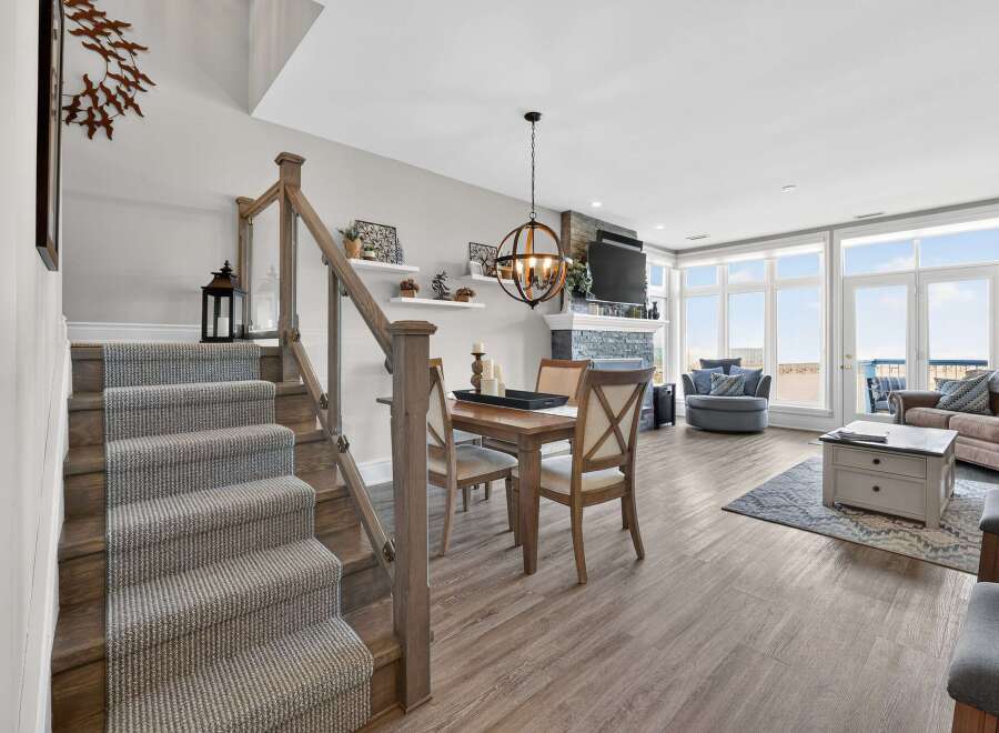 Step into luxury with this stunning property, featuring a beautifully designed staircase leading to a spacious living area.