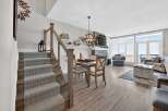 Step into luxury with this stunning property, featuring a beautifully designed staircase leading to a spacious living area.