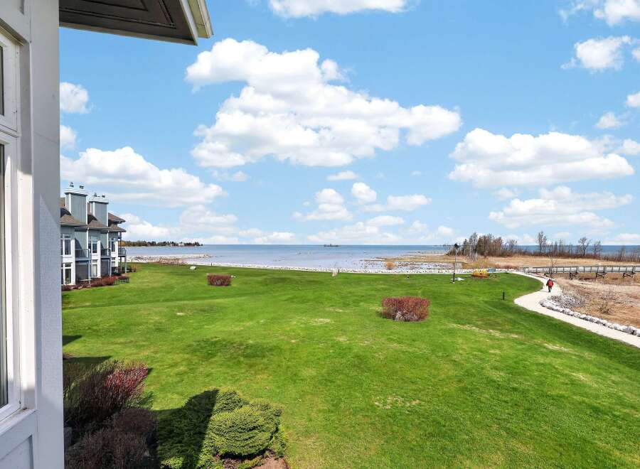 Enjoy breathtaking views from this stunning property! This home features a spacious green lawn, perfect for outdoor activities, and is located near a beautiful lake.