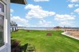 Enjoy breathtaking views from this stunning property! This home features a spacious green lawn, perfect for outdoor activities, and is located near a beautiful lake.