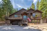 This stunning property boasts a beautiful exterior with a charming wooden design and an inviting entrance.