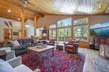 Step into luxury with this stunning living room, featuring a cozy seating area and a beautiful red rug.