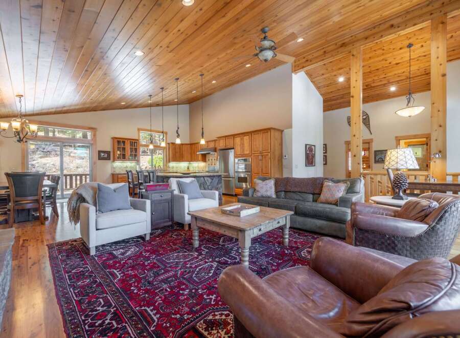 This stunning property boasts a spacious open-concept living area with a gourmet kitchen and a cozy fireplace.