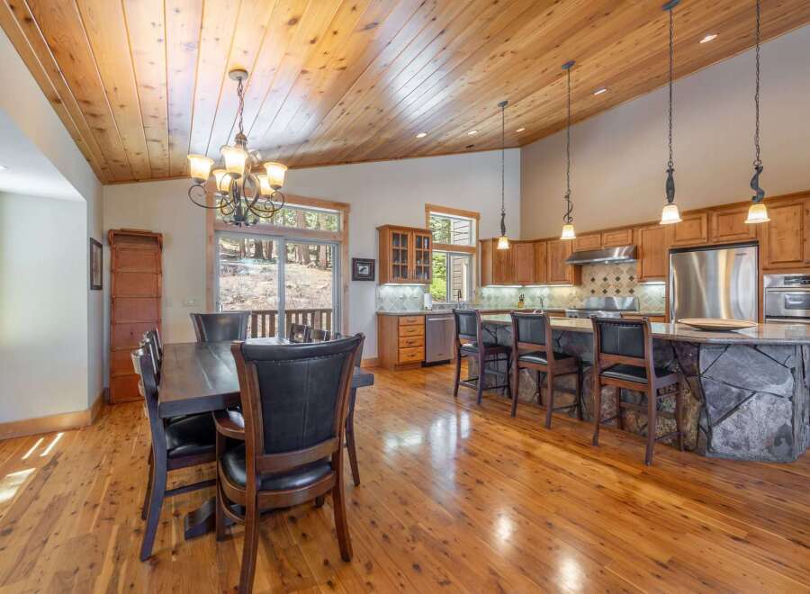Step into luxury with this stunning kitchen featuring a unique stone island and custom cabinetry.