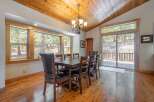 This stunning dining room boasts a warm and inviting atmosphere, perfect for hosting gatherings.