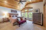 This stunning bedroom boasts a rustic charm with its wooden ceiling and furniture.
