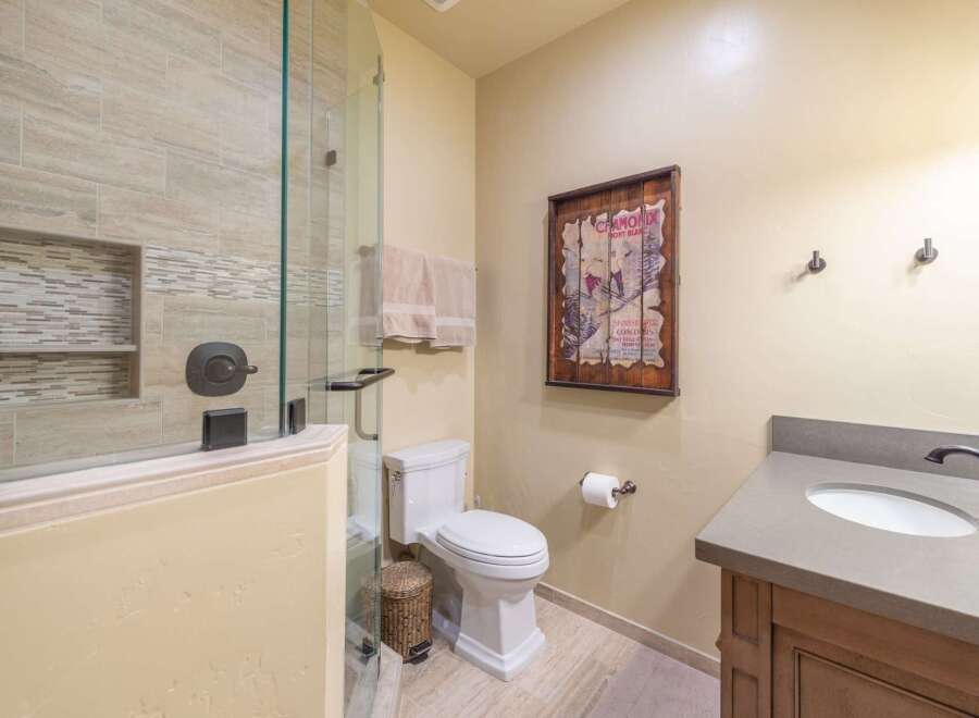 Step into a beautifully designed bathroom featuring a glass-enclosed shower and elegant tile work.